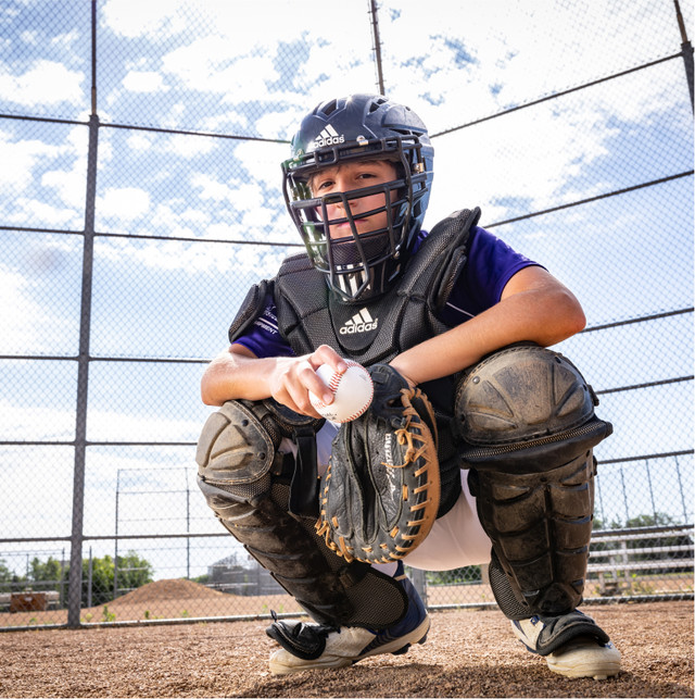 A young boy as an umpire in a baseball game