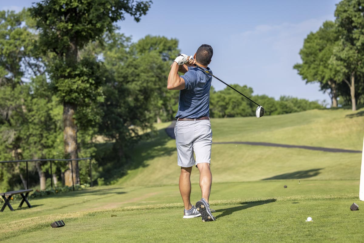 back of guy golfing