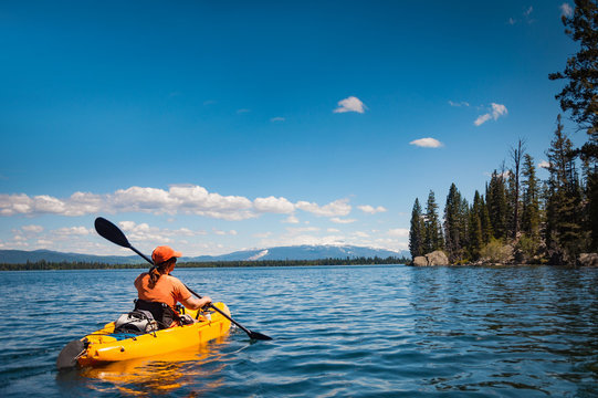 Kayaker paddling on a calm river