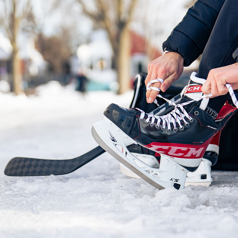 Play It Again Sports Syracuse hockey promotion featuring CCM skates and equipment with Buy, Sell, Trade message.