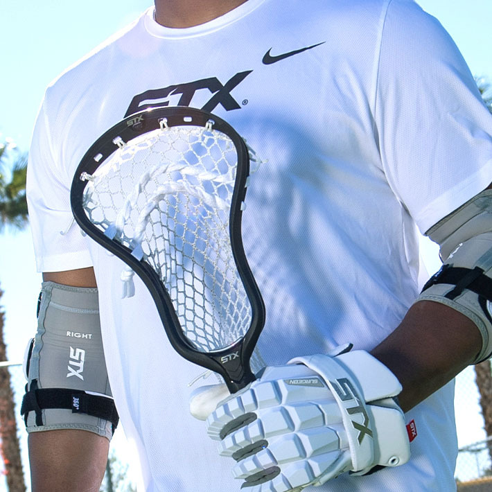Play It Again Sports Syracuse lacrosse promotion featuring STX sticks and gear with Buy, Sell, Trade message.