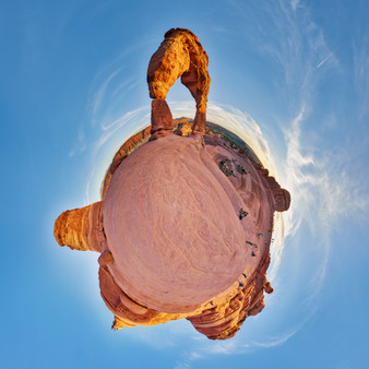 360-degree panoramic Spherescape of Delicate Arch in Arches National Park with the arch at the top against a vibrant blue sky.