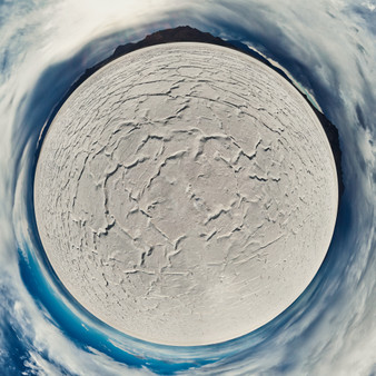 360-degree panoramic view of the Bonneville Salt Flats in Utah depicted as a colorful sphere with blue skies and surrounding mountain ranges.