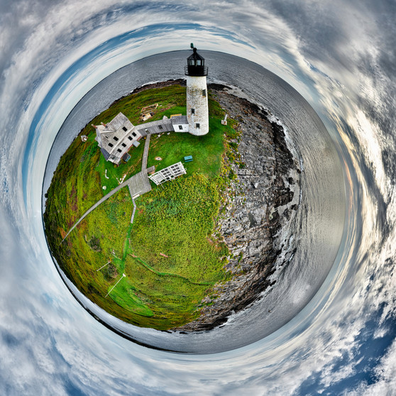 Aerial 360 panorama of Wood Island Light in Maine, where verdant landscapes and rocky coasts merge with vast skies in a harmonious orb