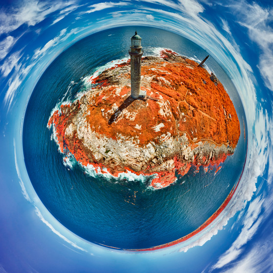 360-degree panoramic view of Cape Ann Light Station in Rockport, Massachusetts, with vivid red vegetation and surreal blue water in a spherical projection.