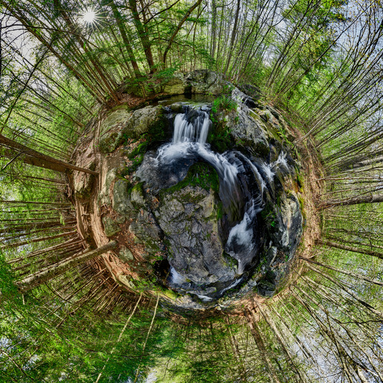 A 360-degree panoramic Spherescape capturing the dynamic waterfall and verdant forest of 'Castle in the Clouds' in Moultonborough, New Hampshire, with a rich color palette of forest greens, earthy browns, and frothy whites