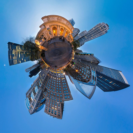 A 360-degree panoramic image of the Stephen A. Schwarzman Building of the New York Public Library at blue hour, surrounded by the cityscape and sky in a spherical composition.