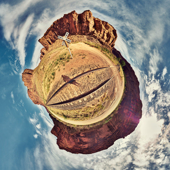 360-degree panoramic Spherescape of unused railroad tracks in Arches National Park, with towering red rock formations and a vast sky.