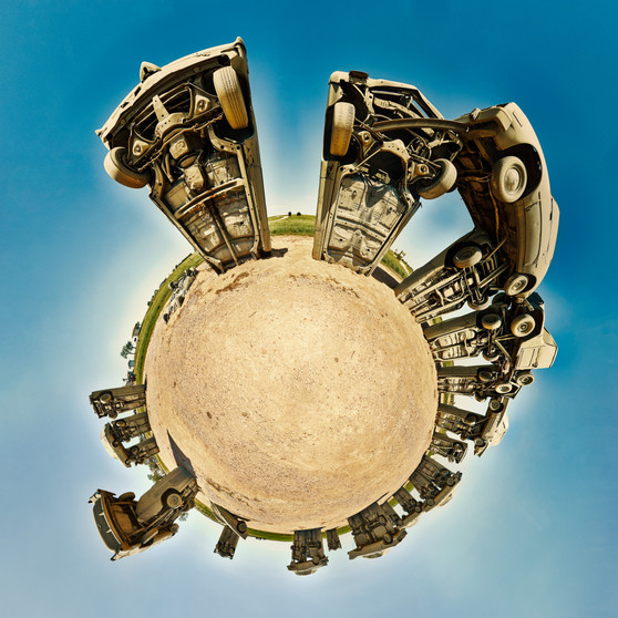 360-degree panoramic view of "Carhenge" in Alliance, Nebraska, featuring upright vintage cars arranged in a circle on a clear day