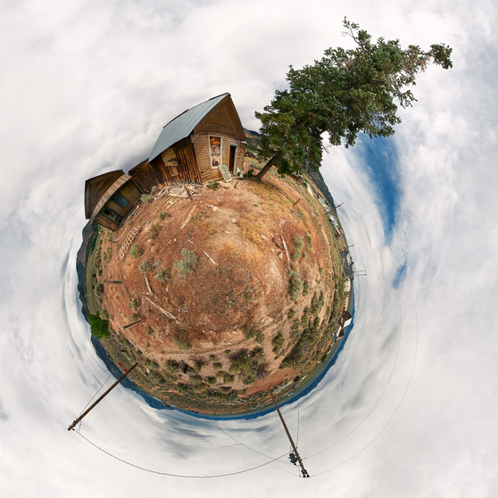 Late afternoon 360-degree panoramic Spherescape of an abandoned house in Cherry Creek, Nevada, with a surrounding desert landscape under a soft sky
