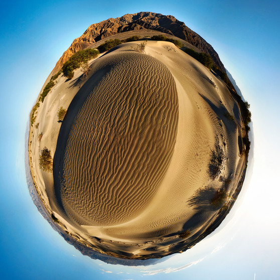 A captivating color panoramic spherescape of the Mesquite Flat Sand Dunes in Death Valley National Park, with rich golden sands and a deep blue sky, encapsulating the vibrant essence of the desert.