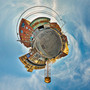 A 360-degree panoramic Spherescape taken in Greenpoint, Brooklyn, featuring a central water tower surrounded by the neighborhood’s distinctive architecture under a sweeping sky.