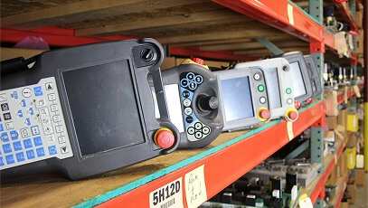 Fanuc teach pendants on warehouse shelf