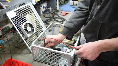 Close-up of TIE Industrial technician working on Fanuc parts