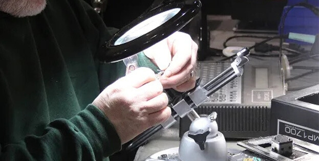 Up close view of TIE Industrial technician fixing a teach pendant