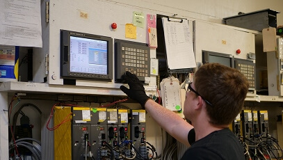 TIE Industrial technician working on Fanuc robot