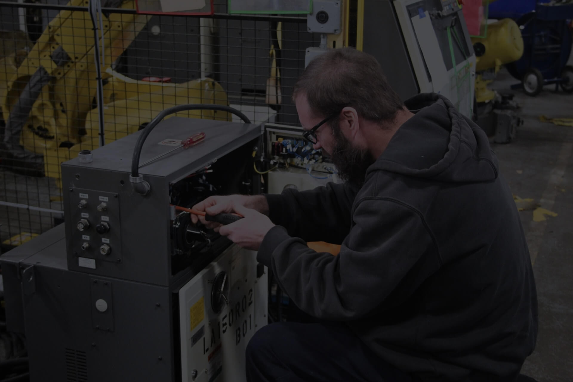 TIE Industrial technician performing robot preventative maintenance