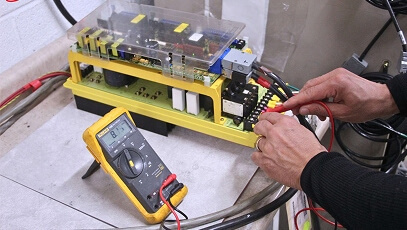 Close-up view of TIE Industrial technician testing a Fanuc unit