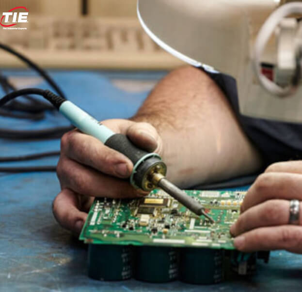 Close-up of TIE employee soldering servo drive