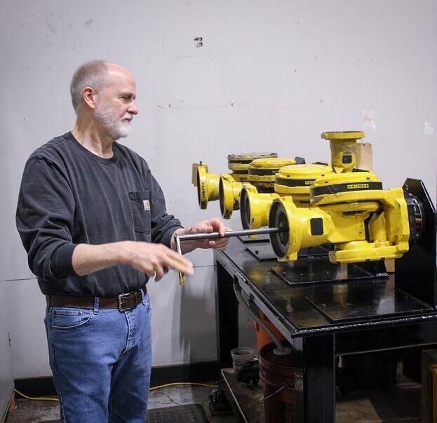 TIE Industrial technician working on Fanuc robot parts