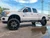 White F250 Platinum with 26x14 American Truxx DNA