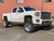 White GMC Denali With Polished American Force Atom Wheels