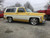 Yellow Chevy Tahoe with American Racing VN506 Rally Polished Rims