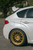 White Subaru WRX Hatchback with Gold Enkei NT03+M Wheels