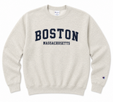 Champion oatmeal heather crewneck sweatshirt featuring navy embroidered appliqué "BOSTON" lettering with Massachusetts below and Champion logo on the sleeve, displayed on a white background.