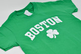 Kids green Boston t-shirt with white Boston lettering and shamrock clover graphic.