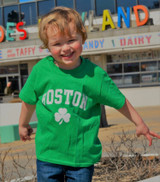 Kids green Boston t-shirt with white Boston lettering and shamrock clover graphic.