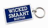 Navy blue Wicked Smaaht Boston acrylic keychain featuring bold white lettering and a silver metal key ring.