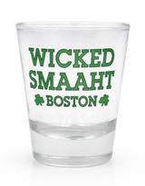 Clear glass Wicked Smaaht Boston Shot Glass featuring green lettering and shamrock accents on a white background.