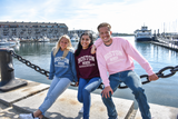 Boston 1630 Distressed Crewneck Sweatshirt by Gildan featuring vintage collegiate lettering, available in Maroon, Indigo, and Light Pink.