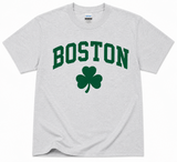 Gildan Ash gray Boston Shamrock T-Shirt featuring green collegiate Boston lettering and shamrock graphic on a classic unisex tee.