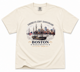 Comfort Colors Boston 250th Anniversary t-shirt featuring a historic tall ship sailing in Boston Harbor with city skyline artwork and commemorative 1776-2026 design.