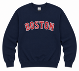 Navy Boston crew sweatshirt featuring a bold red and navy collegiate BOSTON graphic on the front. Available in adult sizes Small through XL.