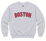 Sport Grey Boston crew sweatshirt featuring a bold red and navy collegiate BOSTON graphic on the front. Available in adult sizes Small through XL.