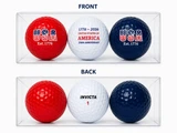 Three patriotic golf balls in a clear display case featuring red, white and blue commemorative 1776-2026 designs.