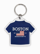 T-shirt shaped acrylic keychain featuring Boston Massachusetts artwork and patriotic flag design on a blue background.