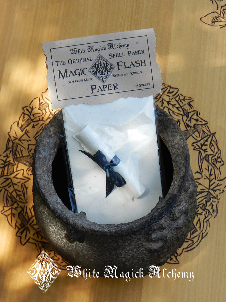 sizzling spell papers in a cauldron on an altar
