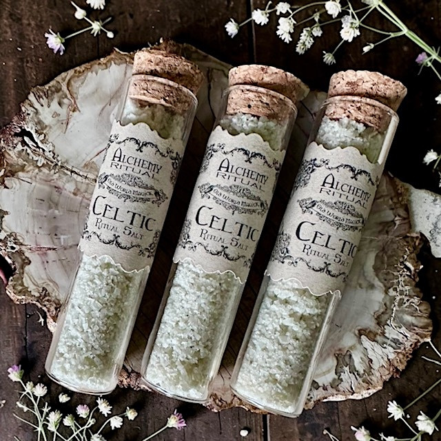 witch salt in premium glass tube on a bed of herbs