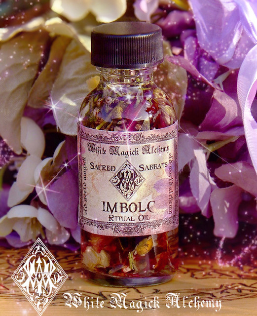 imbolc spell oils on wood table with winter flowers