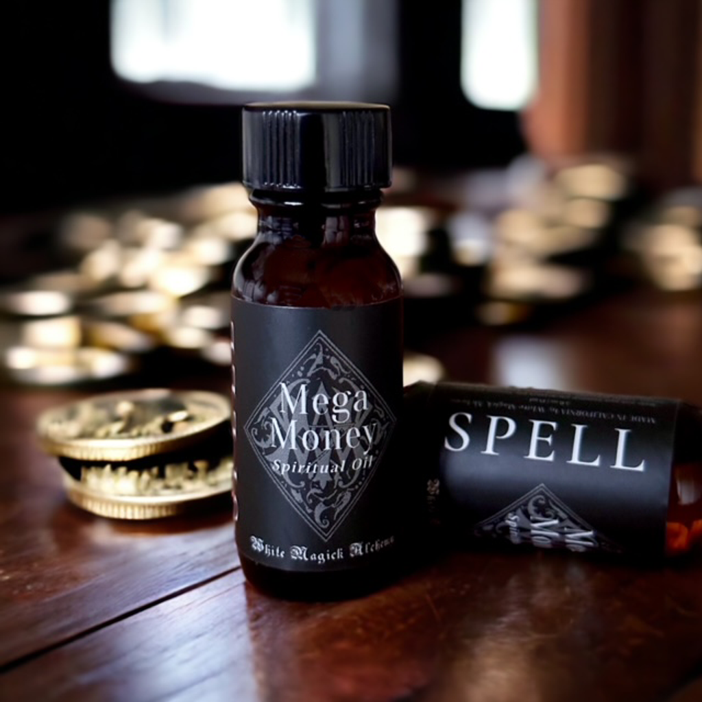 An amber bottle on a wood table with gold coins with a black label that reads Mega Money Spell Oil