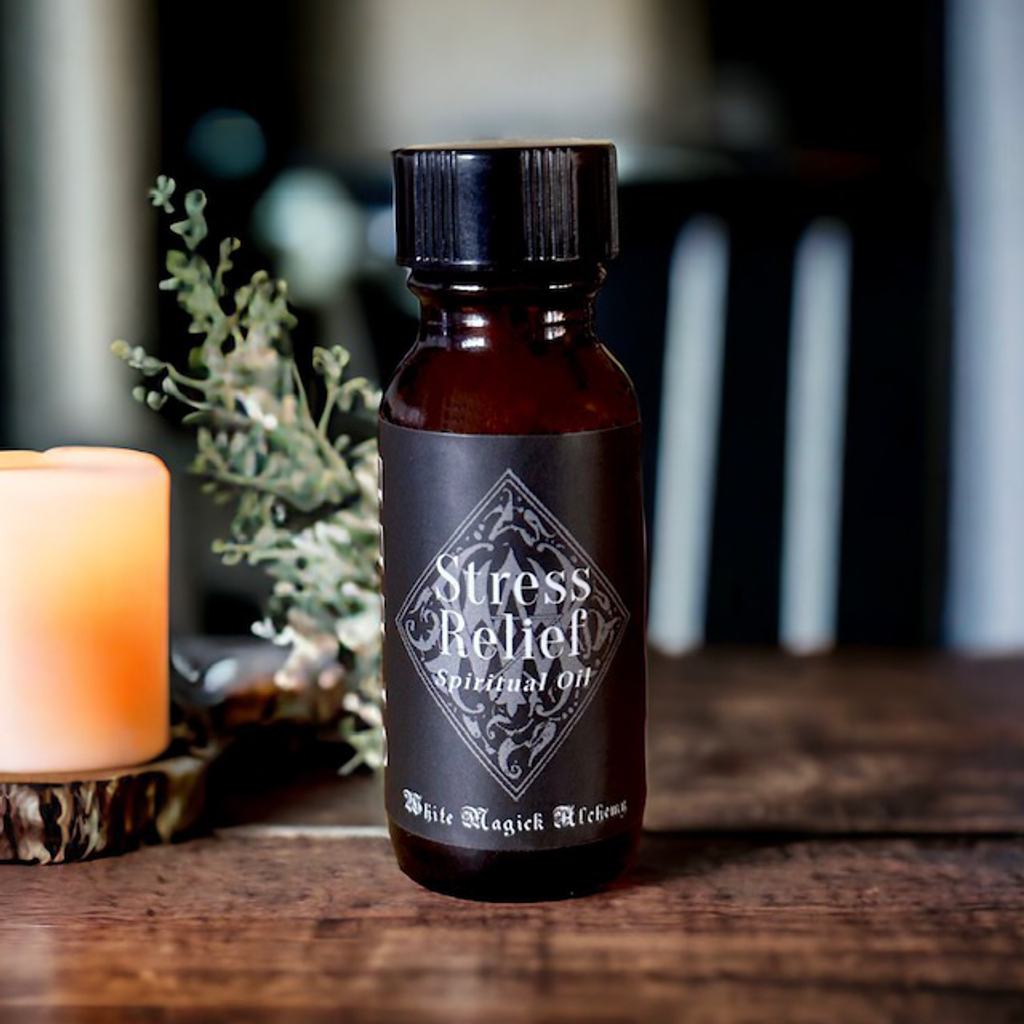 an amber bottle with a black label on a wooden table that reads Stress Relief Spell Oil by White Magick Alchemy