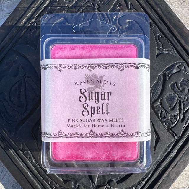 sugar spell scented with pink sugar premium handmade wax melts on black white magick alchemy logo table