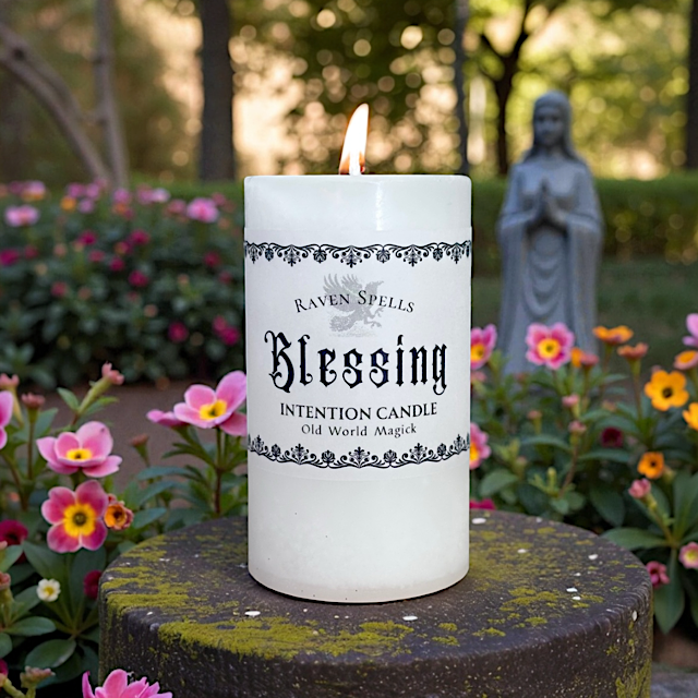 white blessing candle outside in the trees with herbs and flowers