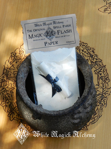 sizzling spell papers in a cauldron on an altar