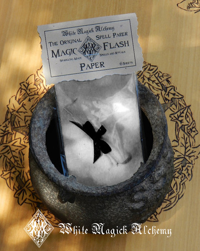 magic flash paper in cauldron on wood table