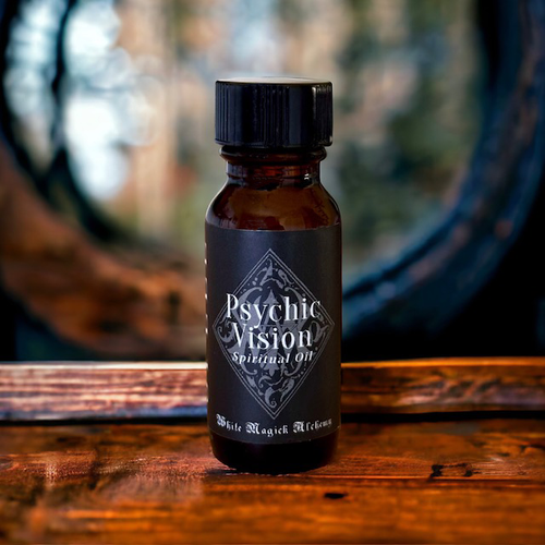 An amber bottle on a wooden table with a black label that reads Psychic Vision Spell Oil by White Magick Alchemy